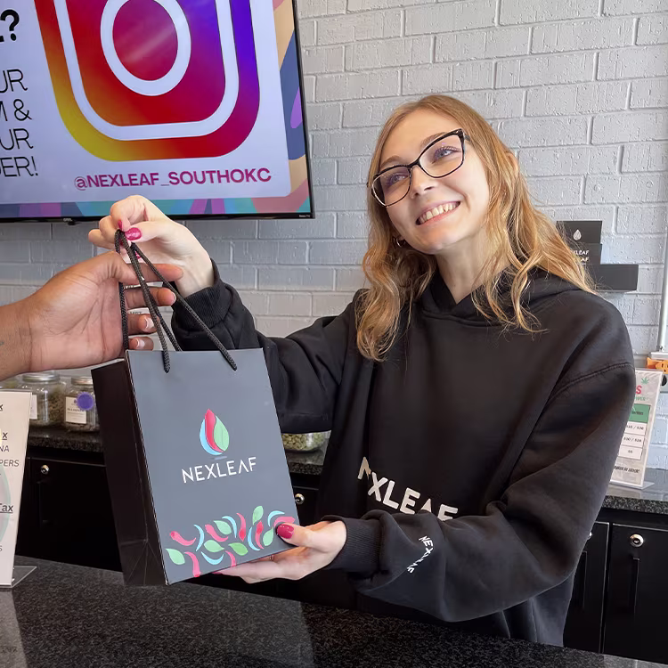 Nexleaf dispensary staff assisting a customer with product selection at an authorized cannabis retail location in Oklahoma